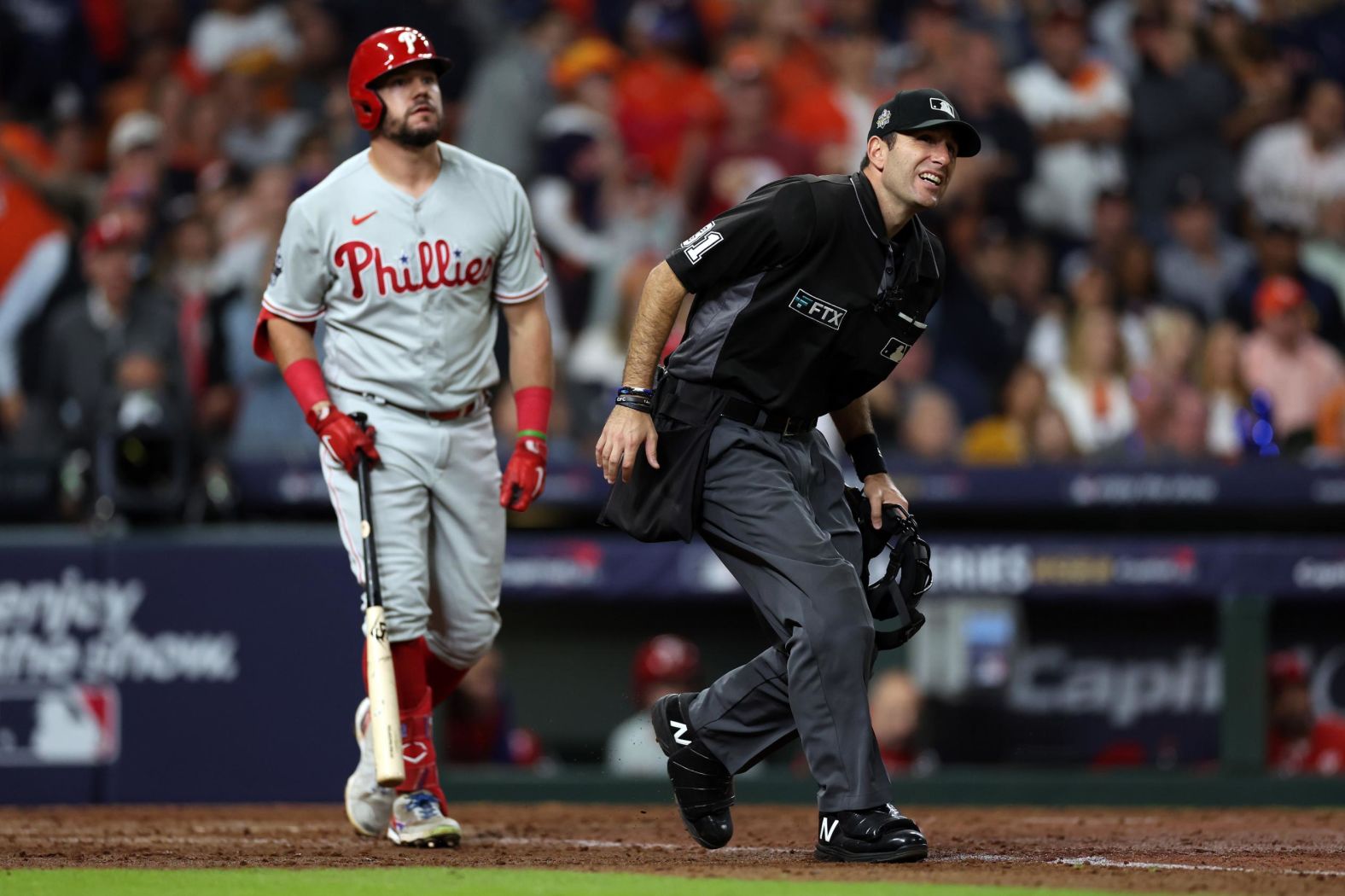 Umpire Pat Hoberg watches to see whether a ball hit by Philadelphia's Kyle Schwarber was a home run or a foul ball in the eighth inning . The ball was initially thought to be fair, but replays showed that it was actually in foul territory.