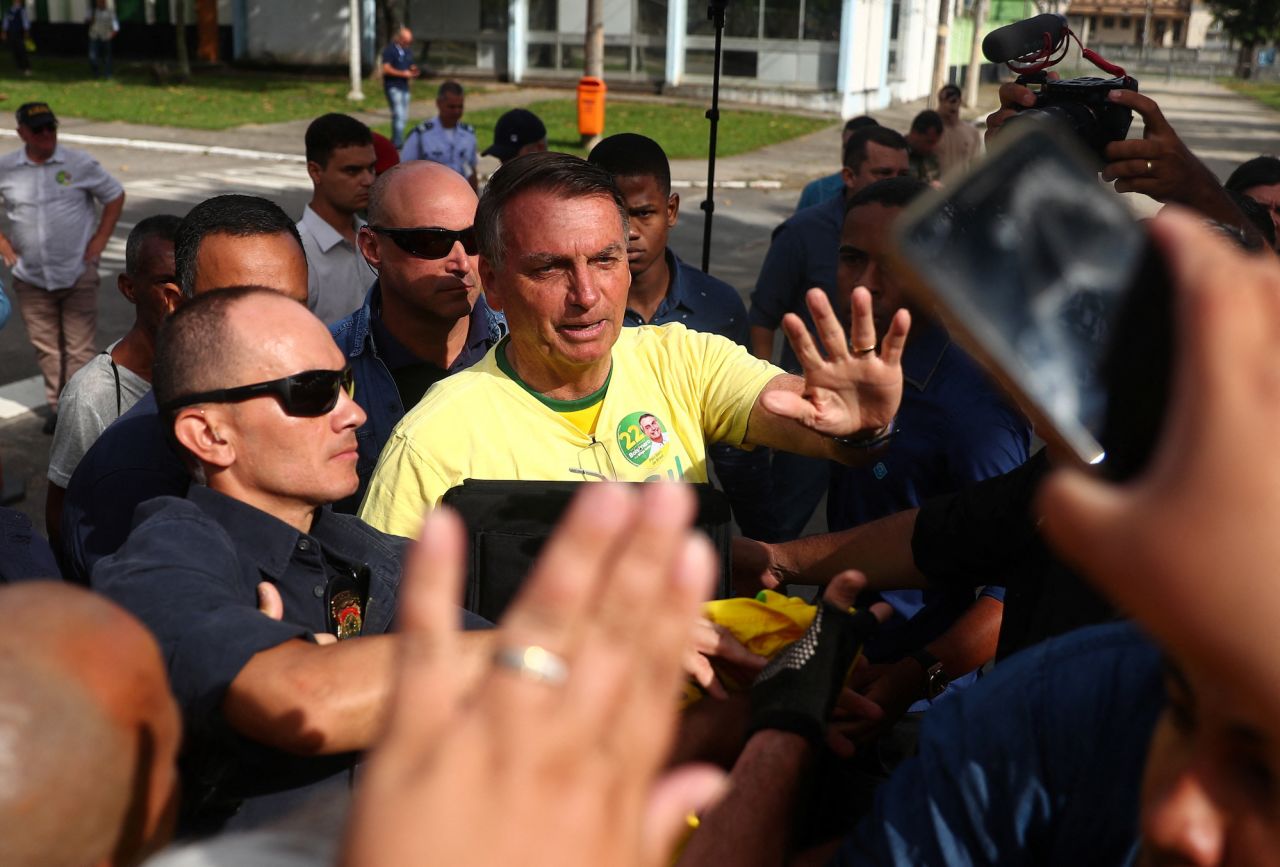 Bolsonaro greets supporters before casting his vote in Rio de Janeiro on October 30.