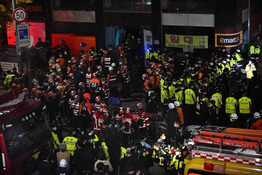 Rescue officials and police gather in the district of Itaewon following the crush.