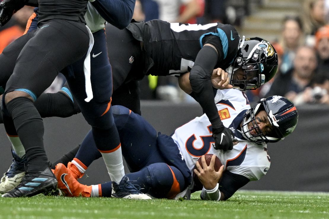 Wilson is sacked by Jacksonville's Arden Key during the first quarter at Wembley Stadium.