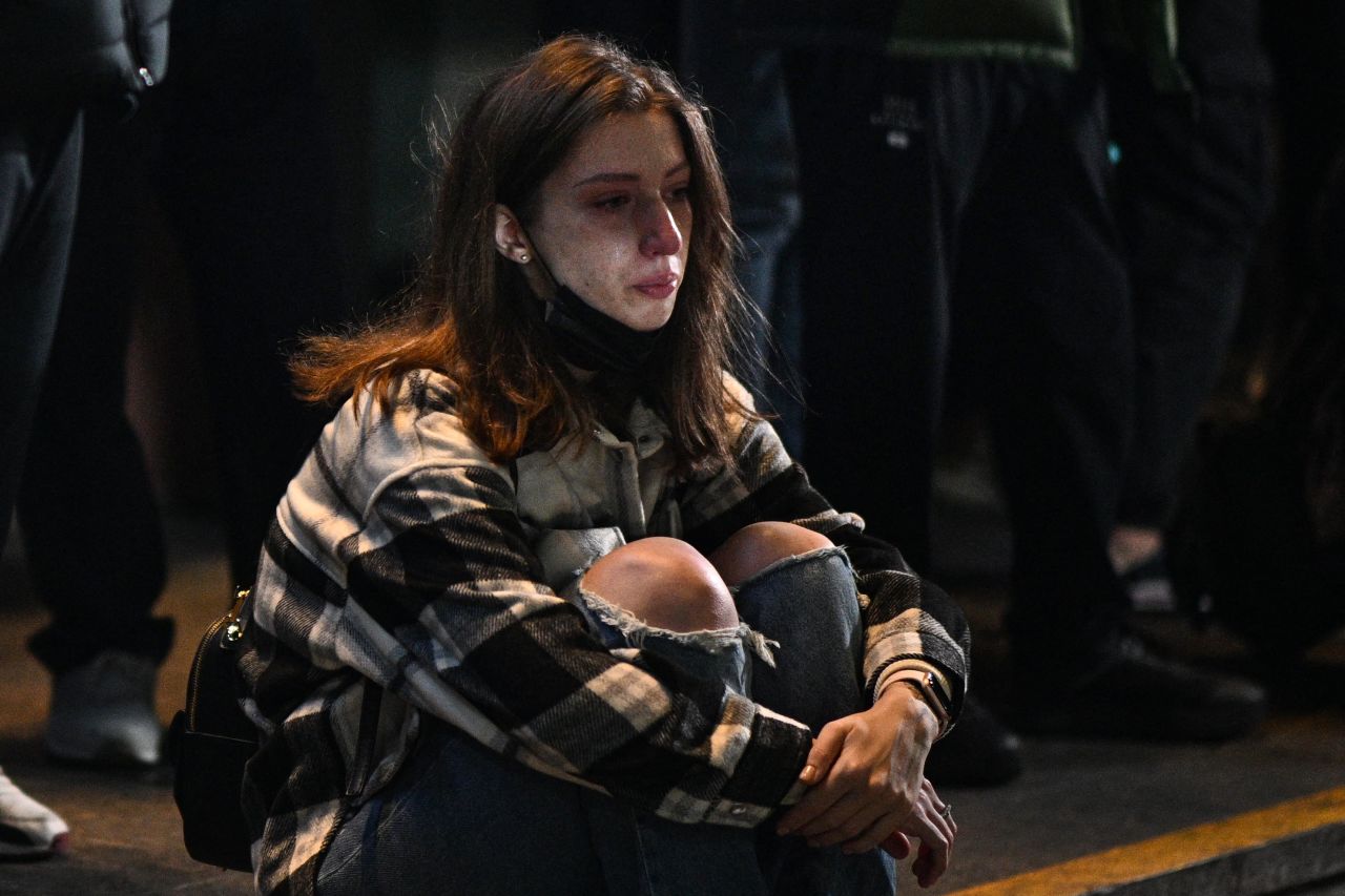 A woman reacts outside the Itaewon subway station.