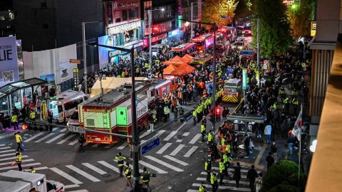 Onlookers, police and paramedics gather in the popular Itaewon nightlife district in Seoul on October 30, 2022.