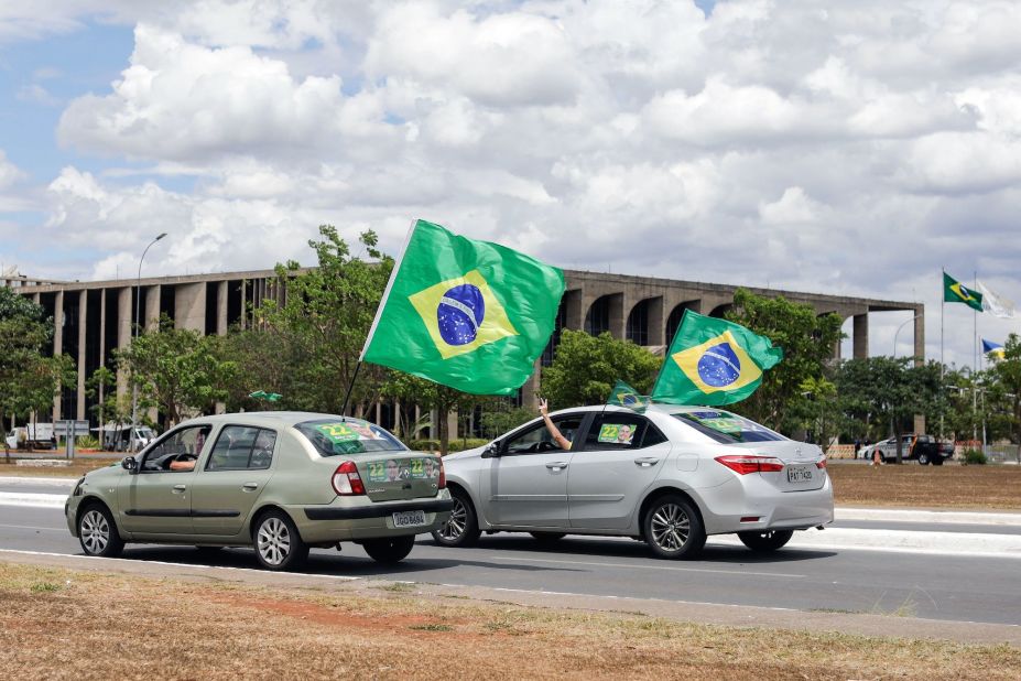 Supporters of incumbent President Jair Bolsonaro wave Brazilian flags in Brasília on October 30.