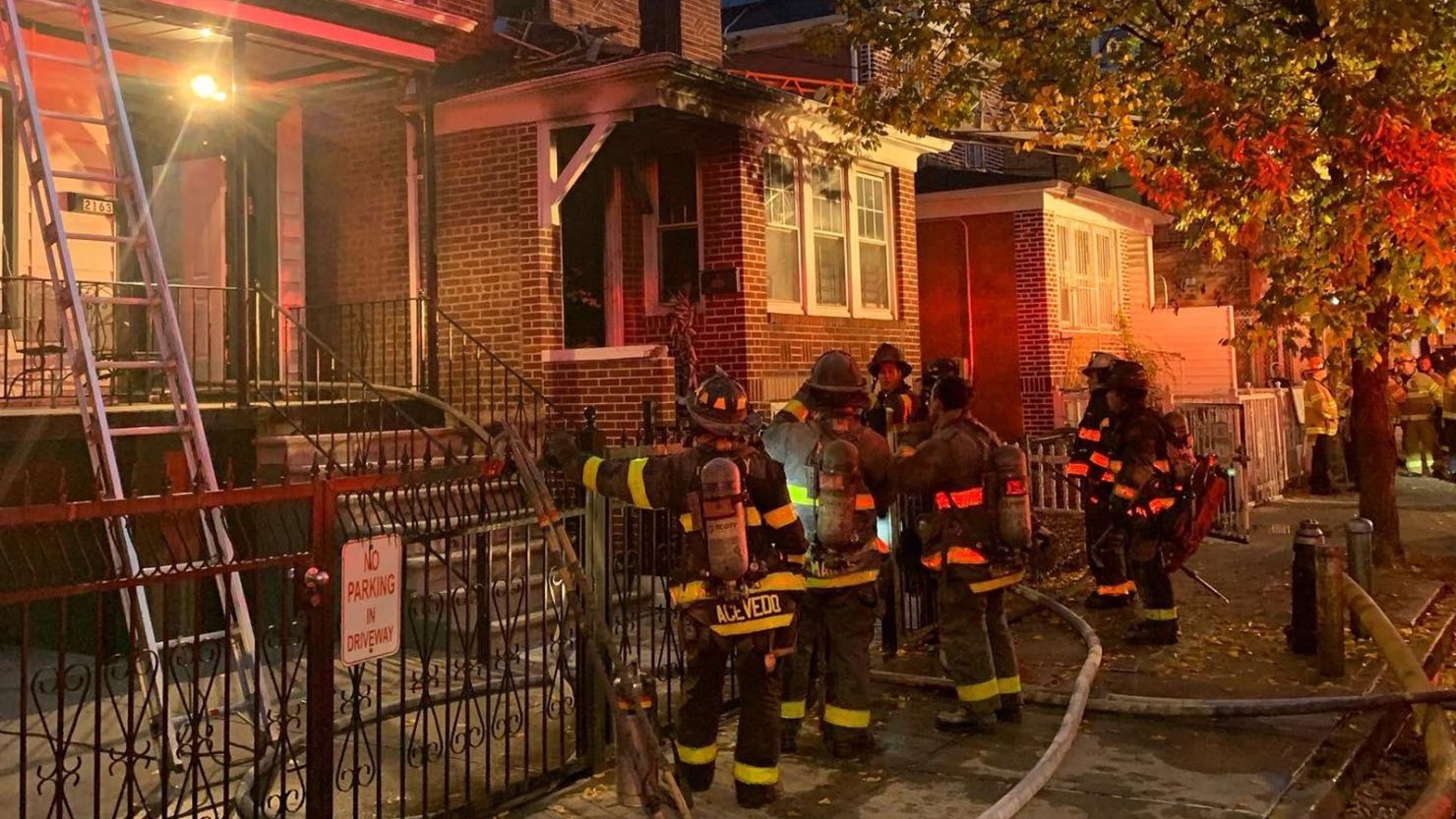 New York Fire Department firefighters at the scene of a house fire in the Bronx that killed four, including a 10-month-old infant, early Sunday morning. 