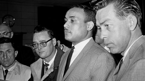 Khalil Islam, center, is booked as the third suspect in the slaying of Malcolm X, in New York on March 3, 1965. 