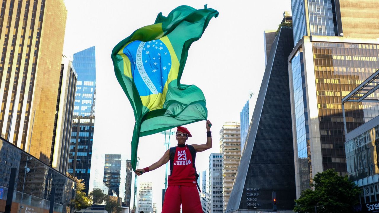A Lula da Silva supporter waves a flag at Avenida Paulista in Sao Paulo on Sunday.