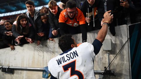 Wilson signs autographs for fans following the Broncos' win over the Jaguars. 