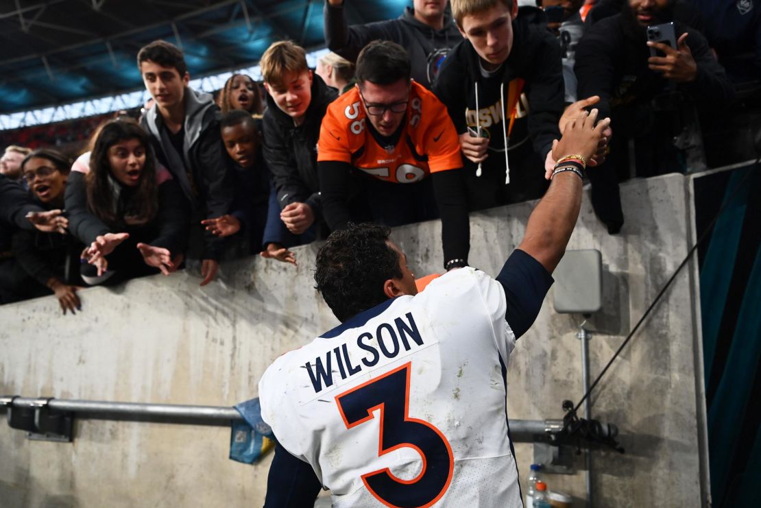 Wilson signs autographs for fans following the Broncos' win over the Jaguars. 