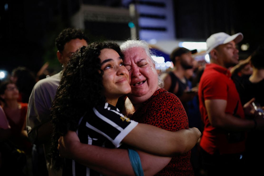 Supporters of Luiz Inacio Lula da Silva react as they wait for results at Paulista Avenue, Sao Paulo. 