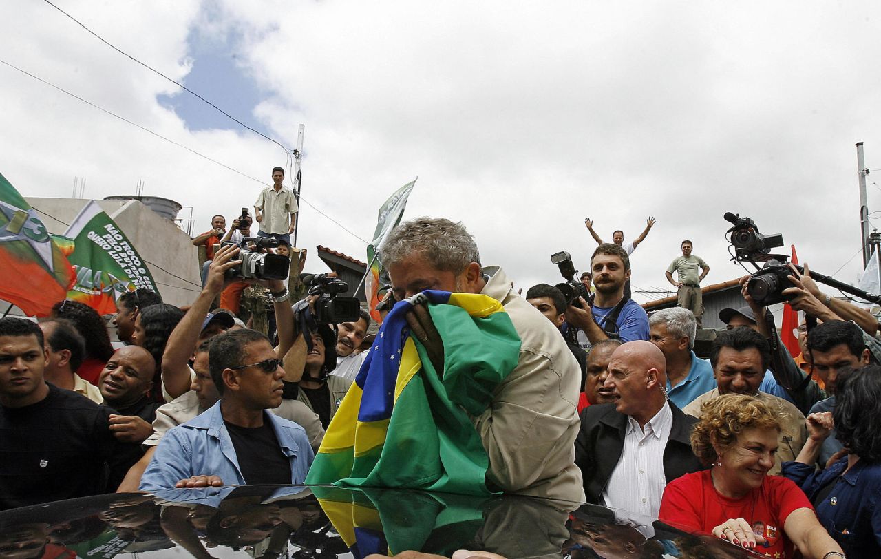 Lula kisses the Brazilian flag as he leaves after casting his vote in São Bernardo do Campo in 2006. Lula ran for his second term in 2006, winning on a run-off vote.