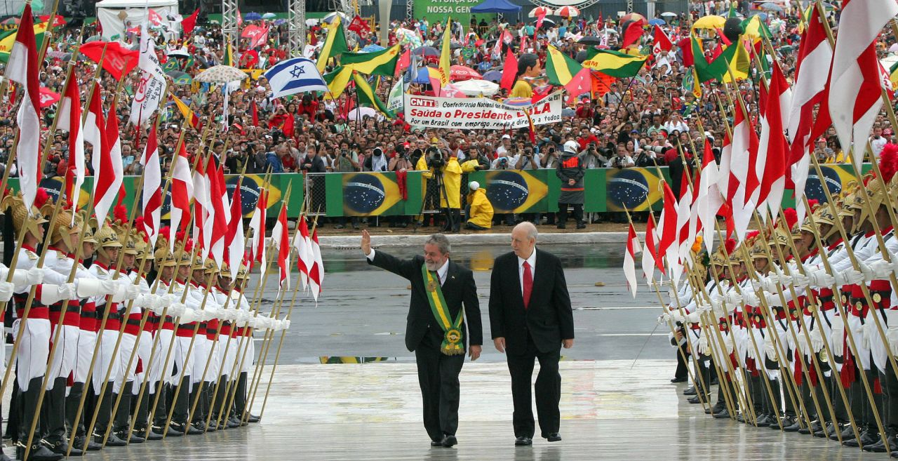 Lula waves as he climbs up the Planalto Palace ramp beside Vice President José Alencar Gomes da Silva during his 2007 inauguration ceremony in Brasília.