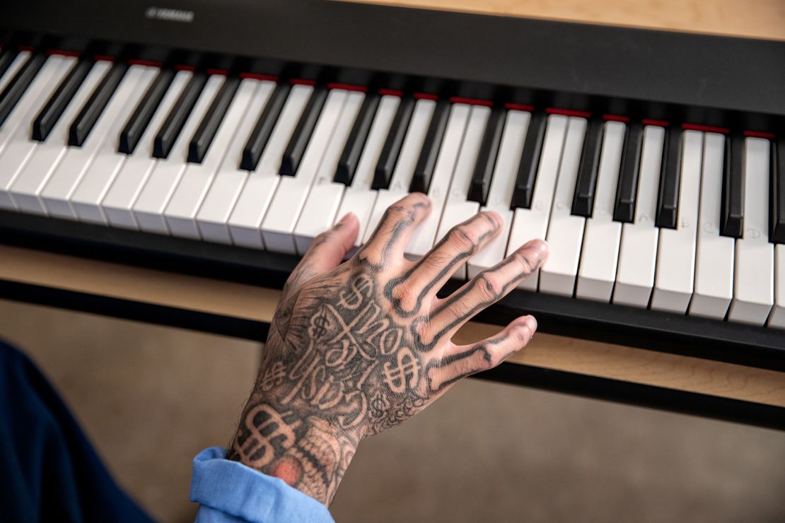 A student plays the piano during a songwriting class at the California Correctional Institution. 