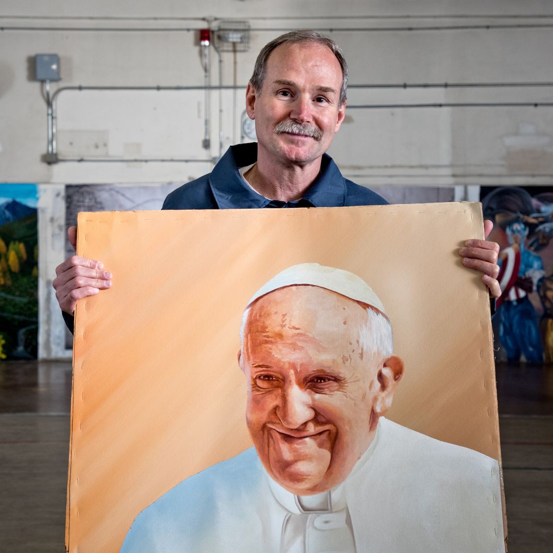 One of phogographer Peter Merts' subjects with an acrylic painting of Pope Francis in 2016. The man was released from prison three years later and now owns a property where he builds micro-homes for homeless people and those who have been released from prison.