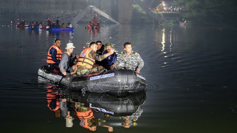 Indian rescuers conduct search operations after a bridge over the Machchu River collapsed in Morbi, about 220 km from Ahmedabad, on the morning of October 31, 2022.