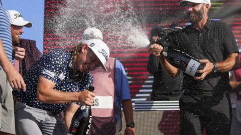 Johnson splashes the champagne on Team Punch Smith's second-place captain.