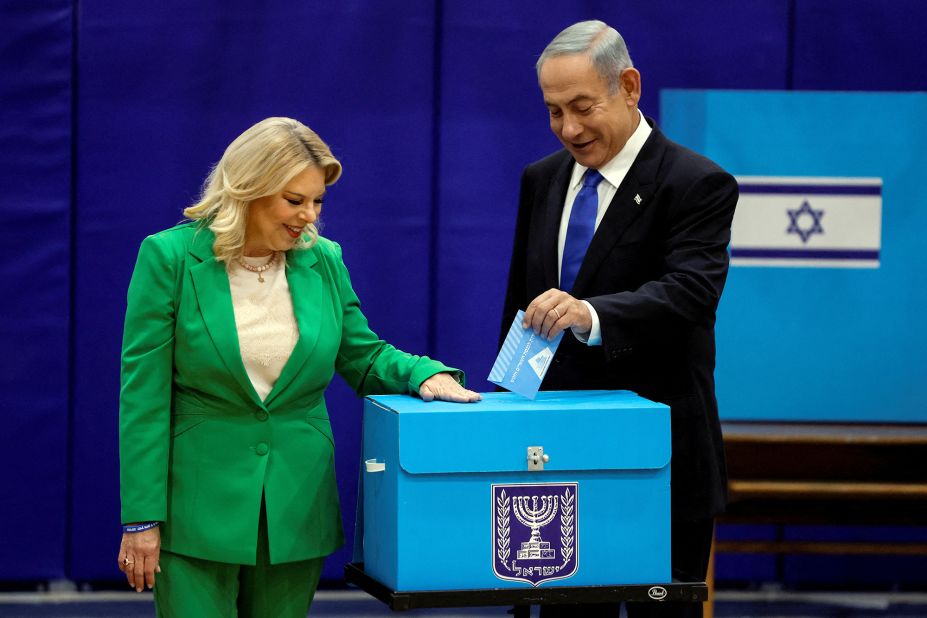 Netanyahu, accompanied by his wife, Sara, casts his ballot at a polling station in Jerusalem in November 2022.