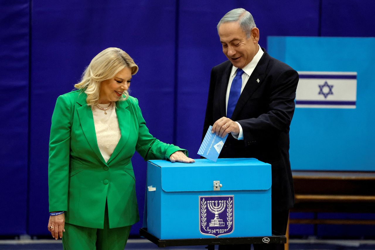 Netanyahu, accompanied by wife Sara, casts his ballot at a polling station in Jerusalem on Tuesday, November 1.