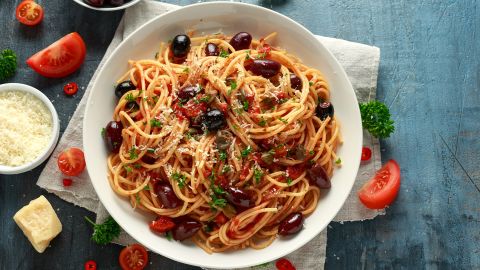 Pasta alla puttanesca features garlic, olives, capers, tomatoes and anchovies.