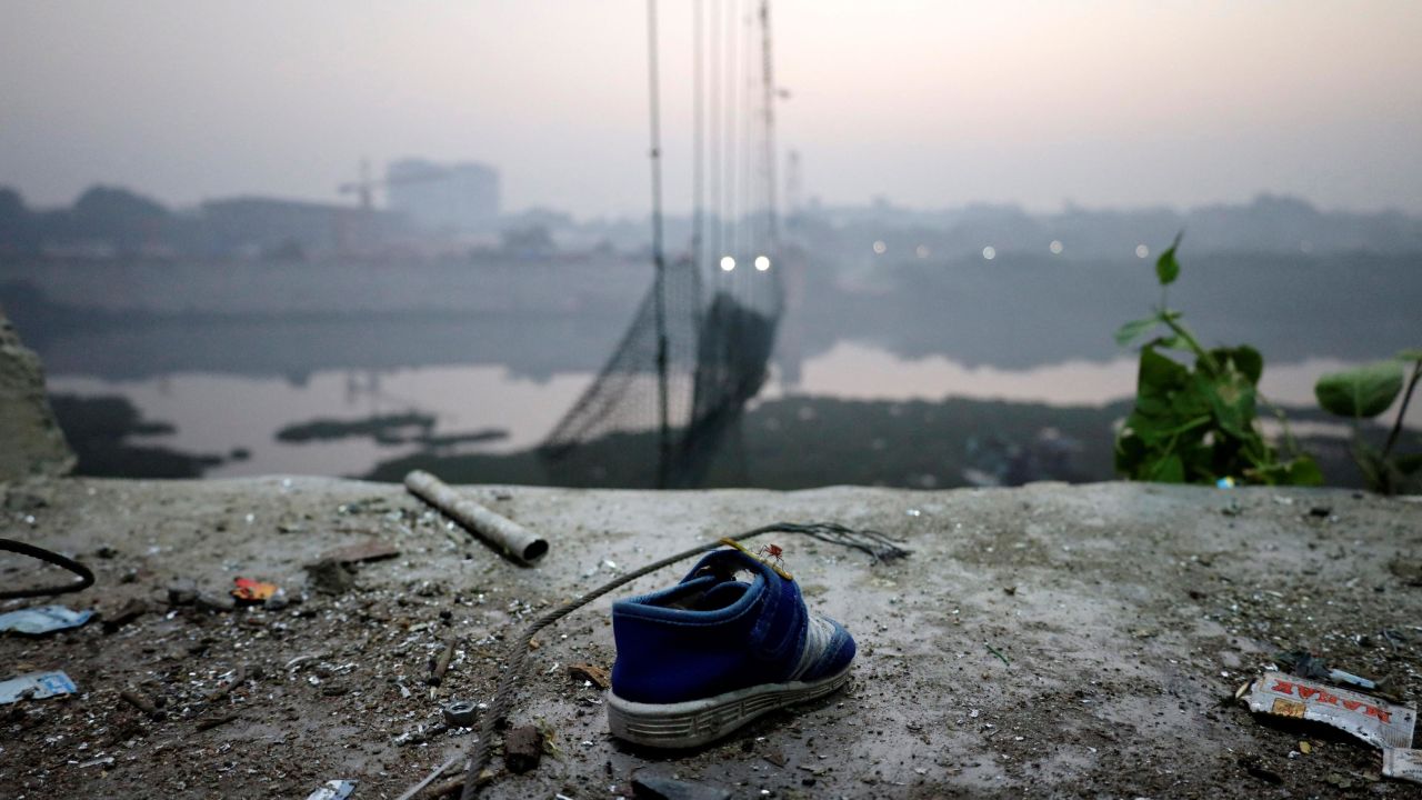 A shoe lies near a damaged suspension bridge in Morbi, India, November 1, 2022. 
