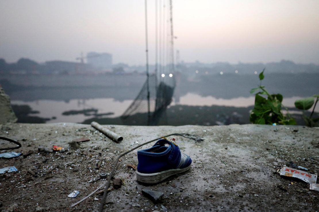 A shoe lies near a damaged suspension bridge in Morbi, India, November 1, 2022. 