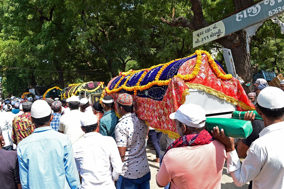 Mourners take part in a funeral procession while carrying the coffins of victims who died after a bridge across the river Machchhu collapsed at Morbi in India's Gujarat state on October 31, 2022. 