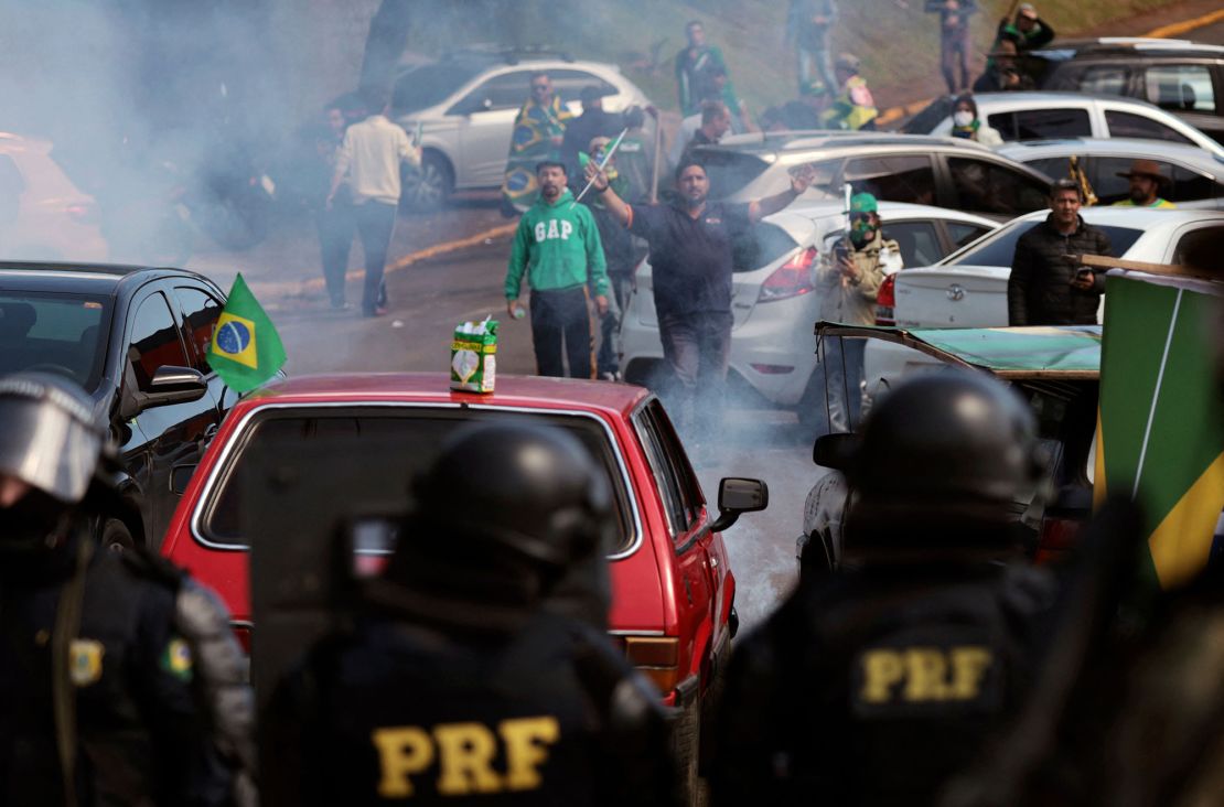 Military police attempt to clear a roadblock in Novo Hamburgo, southern Brazil, on Tuesday.