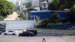 A man passes by a compound of the electronics manufacturer Foxconn, which is under strict access control to prevent Covid-19, in Shenzhen in south China's Guangdong province Saturday, Sept. 03, 2022. 