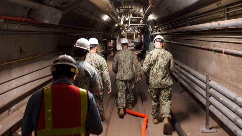 In this file photo provided by the US Navy, Navy and civilian water quality recovery experts are led through the tunnels of the Red Hill Bulk Fuel Storage Facility, near Pearl Harbor, Hawaii, on December 23, 2021. 