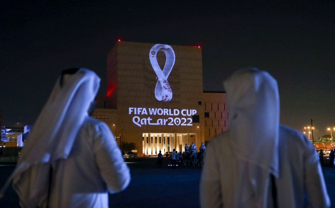 Qataris gather at Doha's traditional Souq Waqif market as the official logo of the 2022 World Cup is projected on a building in September 2019.