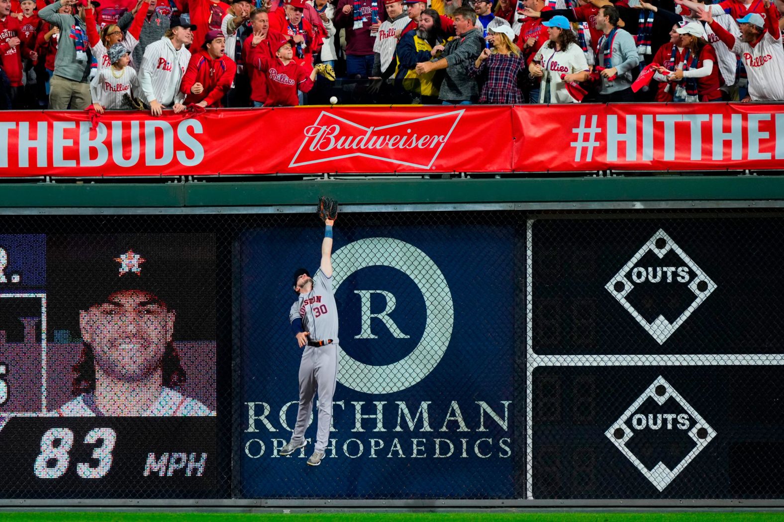 Houston right fielder Kyle Tucker leaps at the wall but can't reach a home run hit by Brandon Marsh in the second inning.