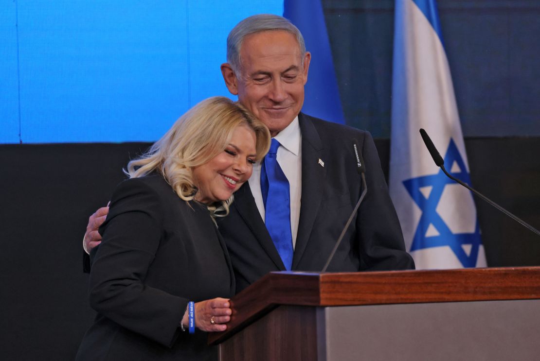 Benjamin Netanyahu,with his wife Sara, addresses supporters at campaign headquarters in Jerusalem early on November 2, 2022.