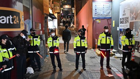 Police stand guard over a crowd in Itaewon, Seoul, South Korea on October 30.