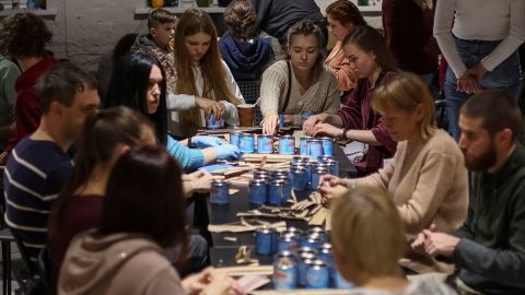 Kyiv residents make trench candles for the Ukrainian military.