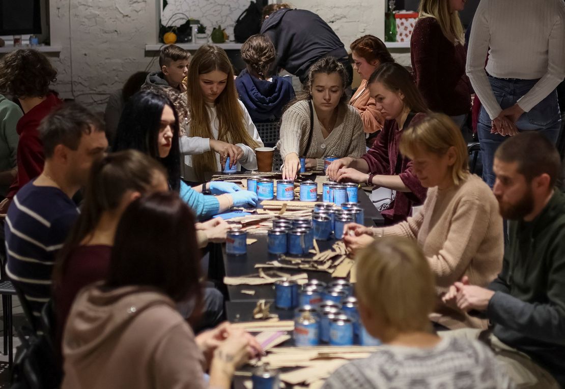 Kyiv residents make trench candles for the Ukrainian military.