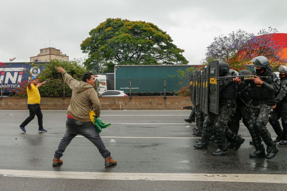 A man argues with riot police as they take position to clear a highway blockade held by supporters of President Jair Bolsonaro on the outskirts of São Paulo on Wednesday November 2.