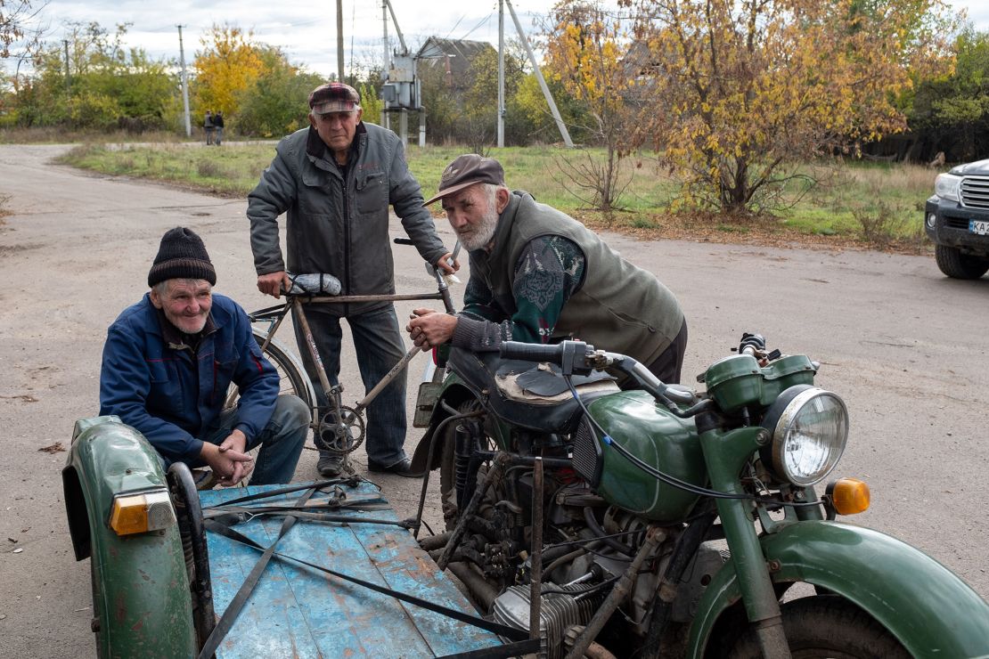 Villagers are pictured in a formerly Russian-occupied town in southern Ukraine's Kherson region.