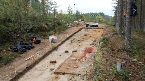 Bright red ocher marked the spot of the grave, uncovered on a service road in a forest in Eastern Finland.