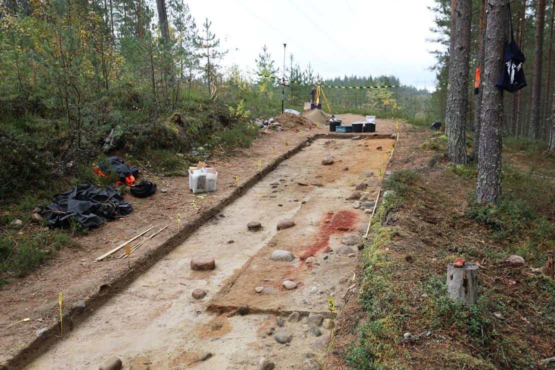 Bright red ocher marked the spot of the grave, uncovered on a service road in a forest in Eastern Finland.