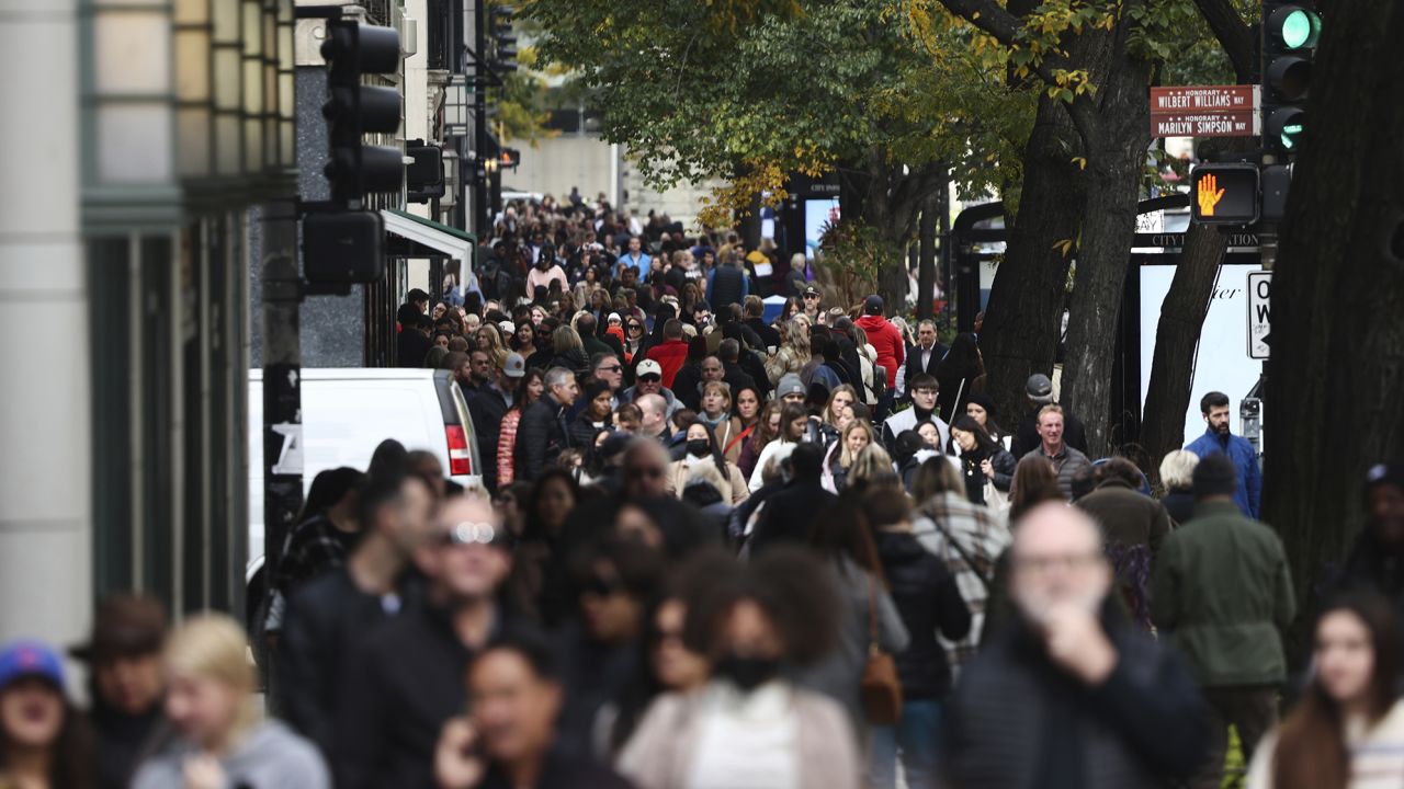 People walk in Chicago, IL, on October 14.