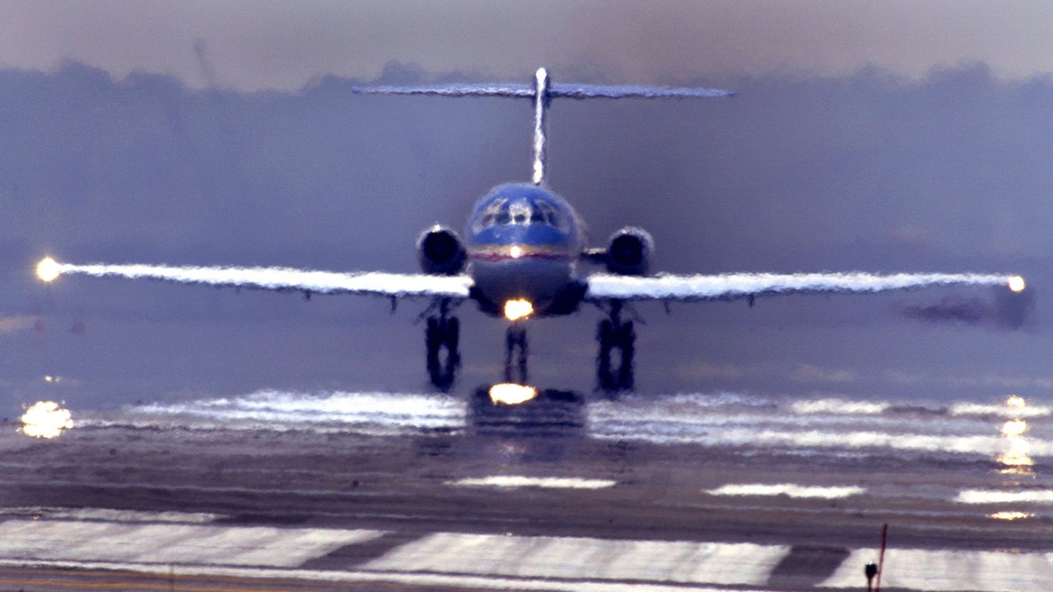 High temperatures and heat waves distort the image of a passenger jet as it taxis for take-off at Washington, DC's Ronald Reagan National Airport, 01 August 2002. (PAUL J. RICHARDS/AFP via Getty Images)