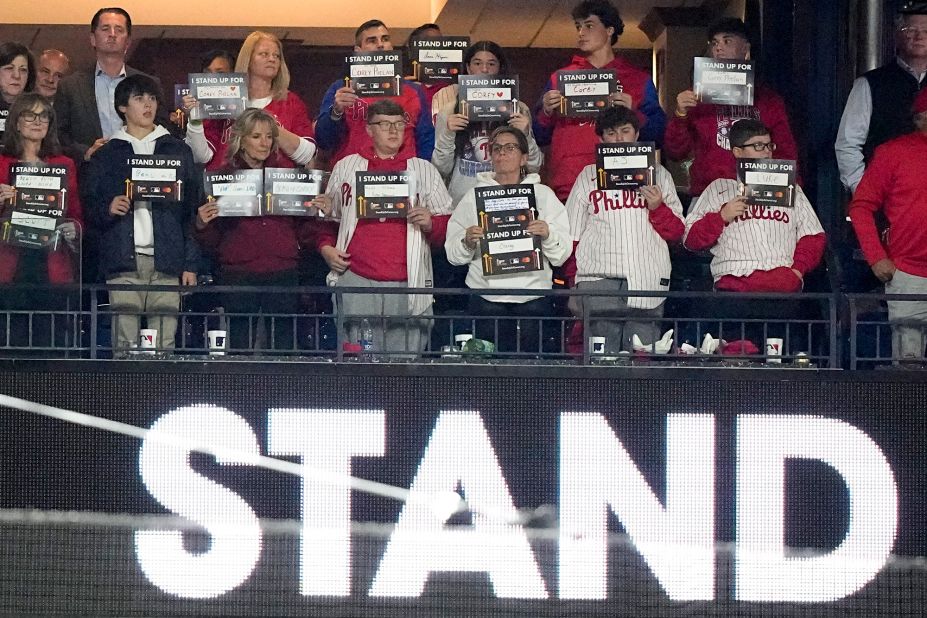 <a href="https://www.cnn.com/2022/10/31/politics/jill-biden-world-series-philadelphia" target="_blank">First lady Jill Biden</a>, third from left in front, hold signs for a Stand Up To Cancer campaign after the fifth inning of Game 4. The first lady attended the game in Philadelphia as part of the Biden administration's Cancer Moonshot initiative. She has made her love of the Phillies well known and has longstanding ties to the city.