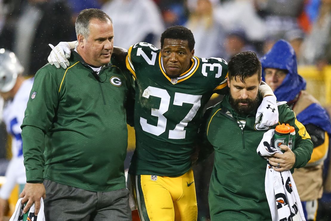 Shields is helped off of the field after taking a hit in the second quarter of the game against the Dallas Cowboys at Lambeau Field on December 13, 2015.