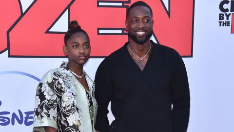 Dwyane Wade (right) and his daughter Zaya Wade arrive for the "Cheaper by the Dozen" Disney premiere at the El Capitan theatre in Hollywood, California, March 16, 2022.