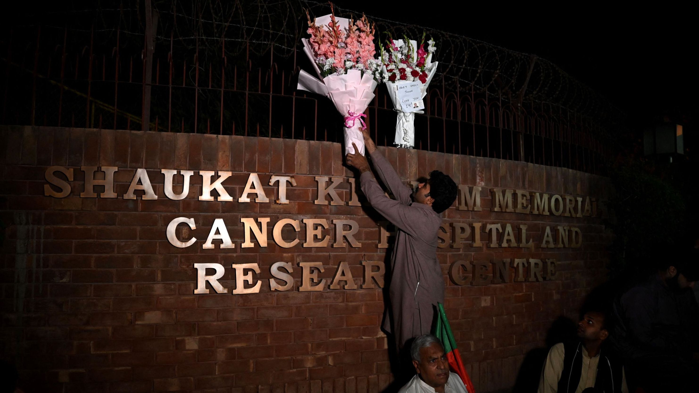 A person places flowers outside the hospital where Pakistan's former Prime Minister Imran Khan is admitted after <a href="https://www.cnn.com/2022/11/03/asia/imran-khan-pakistan-rally-intl" target="_blank">being shot in the leg</a> at a rally in Lahore, Pakistan, on Thursday, November 3. 