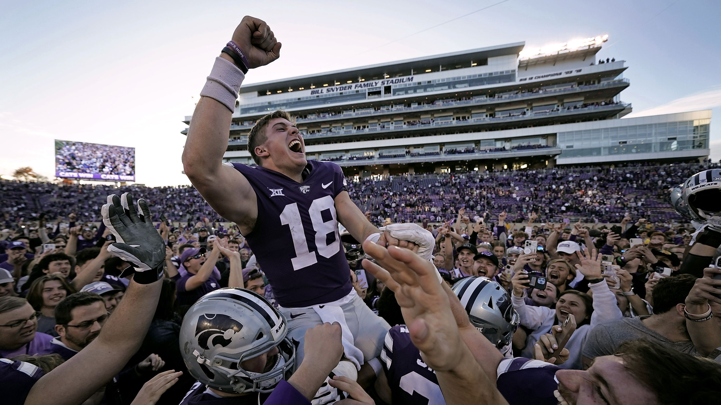 Kansas State quarterback Will Howard celebrates with the crowd as he is carried off the field by teammates after winning a college football game against Oklahoma State on Saturday, October 29. Kansas State won 48-0.