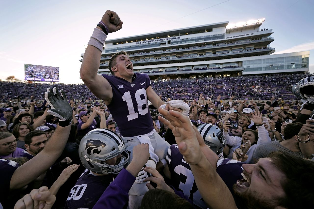 Kansas State quarterback Will Howard celebrates with the crowd as he is carried off the field by teammates after winning a college football game against Oklahoma State on Saturday, October 29. Kansas State won 48-0.