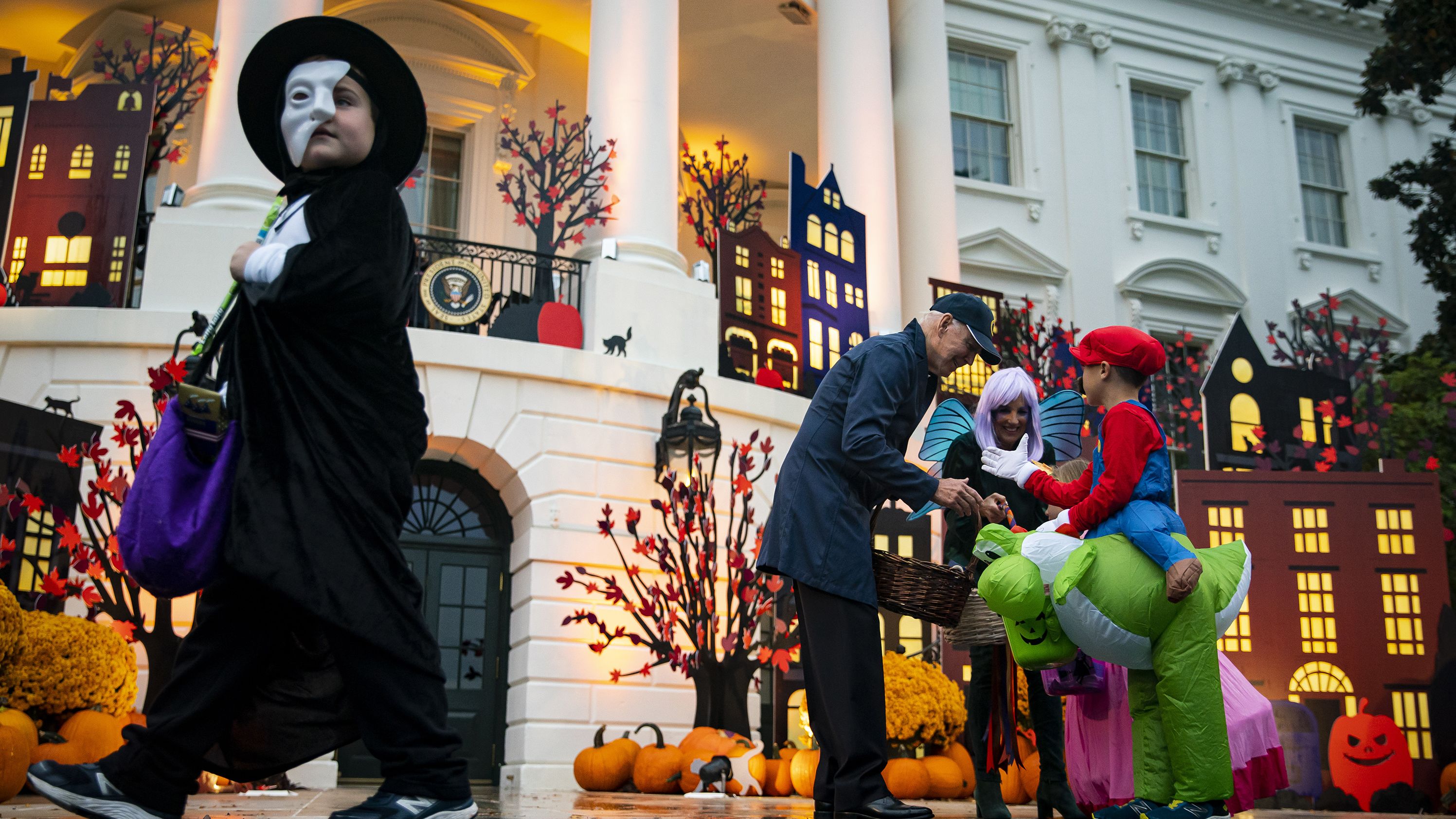 US President Joe Biden and first lady Jill Biden greet children during a Halloween event on the South Lawn of the White House on Monday, October 31.