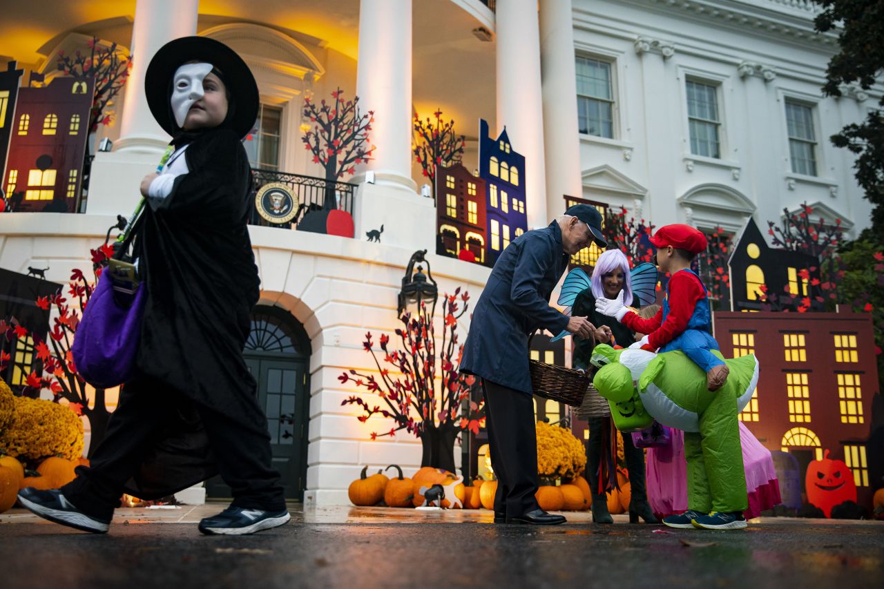 US President Joe Biden and first lady Jill Biden greet children during a Halloween event on the South Lawn of the White House on Monday, October 31.