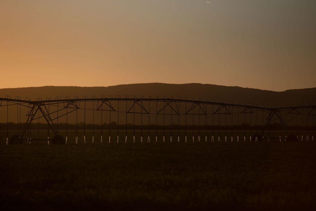 Irrigation systems run as the sun sets near Salome.