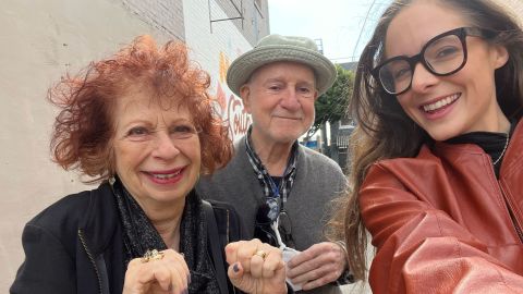 Annie Korzen's husband, film producer Benni Korzen (center), joins Korzen and Morrison for a selfie. Benni appears in some of their TikToks, and some viewers have purchased his art after seeing it hanging in Korzen's home.